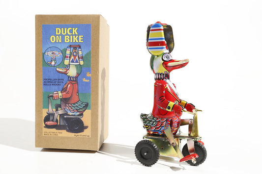 Tin toy duck in tricycle-winding