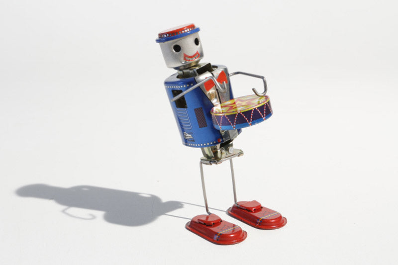 Tin toy robot plays drums-tuned