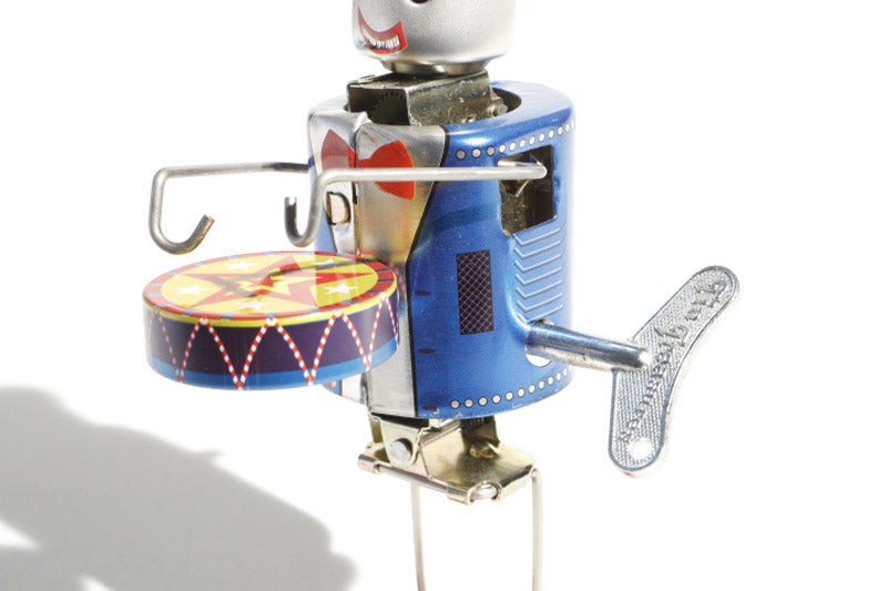 Tin toy robot plays drums-tuned